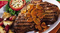 T. bone steak with a side dish