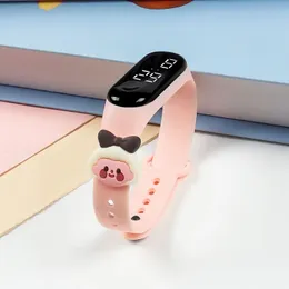pink silicone strap touch screen LED digital watch with a cute cartoon decorative charm.
