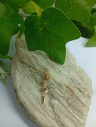 Gold Plated Pendant with Wavy Ribbon Design and Clear Stones