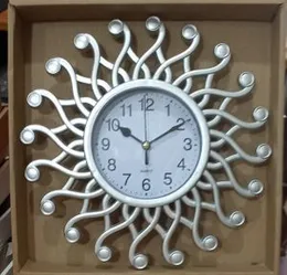 Sun-shaped silver quartz wall clock.