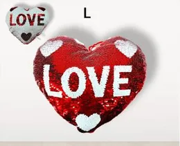 ed and white heart-shaped reversible sequin "LOVE" pillow.