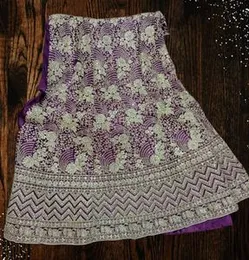 Purple bridal lehenga material with silver sequins and patterned thread work.