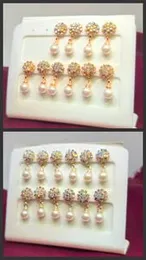 Pair of Gold Round Diamond Earrings with a pearl drop.