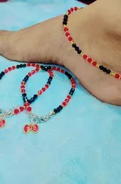 Red and black beaded anklet pair