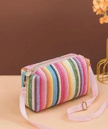 Colorful rainbow pattern woven straw crossbody bag.
