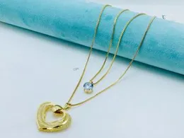 18k gold plated necklace with a heart pendant and a cubic zirconia stone.