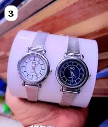 SQ-branded analog quartz watches with silver mesh straps and black and white dials.