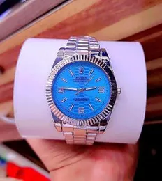 Rolex Oyster Perpetual "Land-Dweller" watch with a fluted bezel and a blue dial.