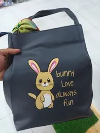 tote bag featuring a cartoon bunny and the phrase "bunny Love always fun."
