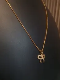 Fashionable Gold-Plated Bow Necklace with Rhinestones