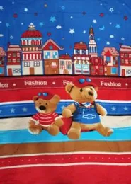 teddy bear plush toy on a patterned blanket