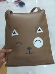 brown tote bag or shoulder bag featuring a stylized animal face design.