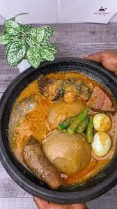 Kokonte with groundnut soup( Intestine & tilapia Fish)