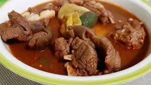 Fufu with light soup and cow meat