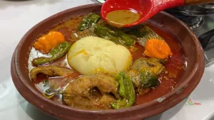 Banku with palm nut soup with cow face