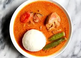 Rice Balls with palmnut soup (chicken and cow feet)
