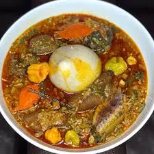 Banku and okro soup with salmond, cowmeat, wele