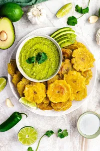 Patacones (green plantain mashed  and fried) with mashed beans