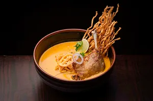 KHAO SOI WITH CRISPY DUCK LEG CONFIT.