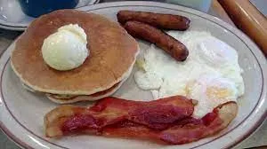 Pancakes With 2 Eggs And Breakfast Meat